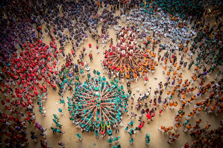 The Colla Jove de Castellers from Sitges and the Colla Castellera Sant Pere i Sant Pau perform in a joint round during the Tarragona Human Tower Competition. – © David Oliete