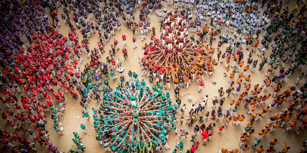 The Colla Jove de Castellers from Sitges and the Colla Castellera Sant Pere i Sant Pau perform in a joint round during the Tarragona Human Tower Competition. – © David Oliete