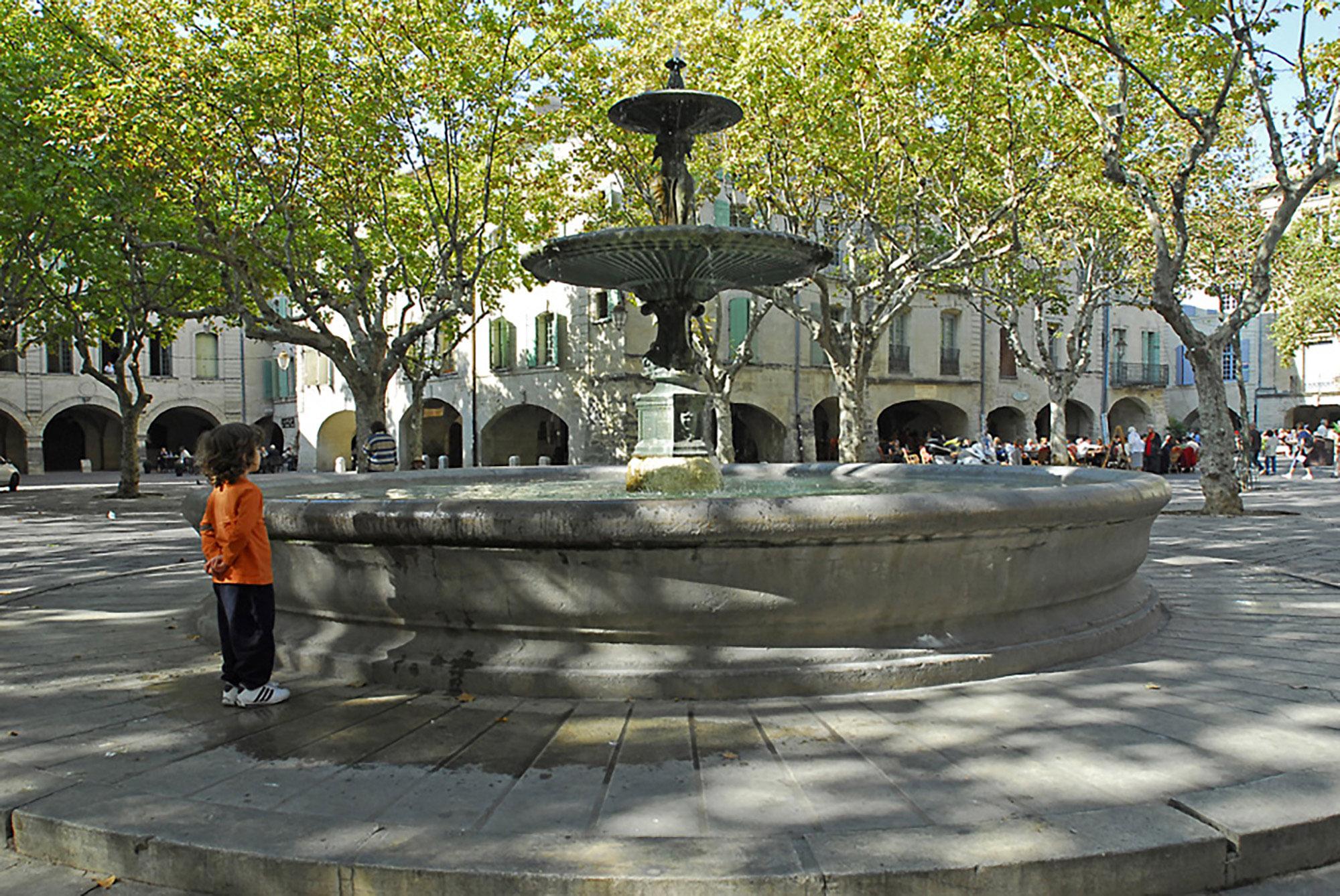 Place aux Herbes with central fountain, installed in 1855. - © Aline Périer /Uzès Tourist Office