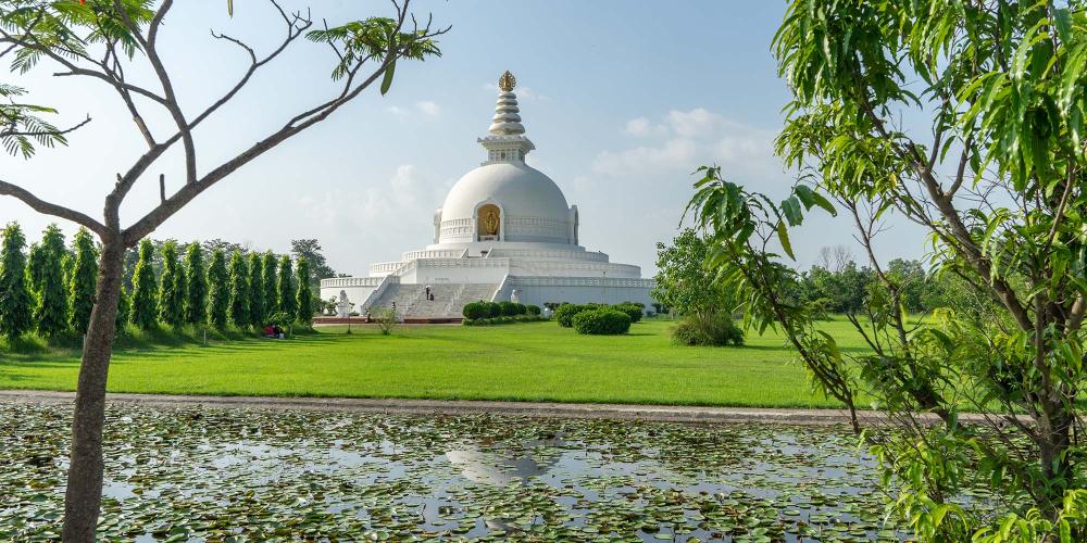 The World Peace Pagoda at the northern end of Lumbini was built by Japanese Buddhists and forms an axis with the Mayadevi Temple down the centre of the site. – © Michael Turtle