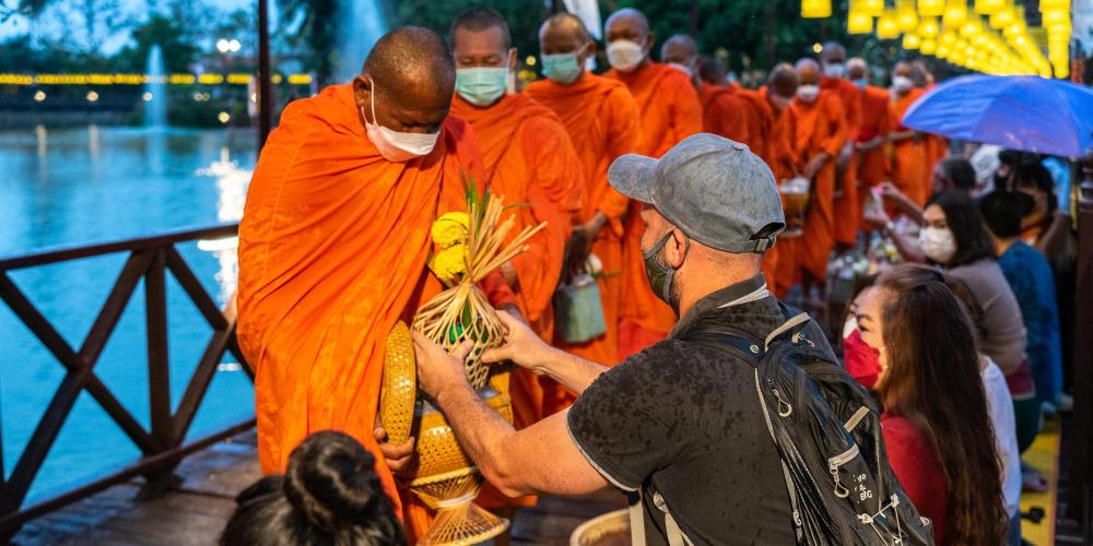 Foreign tourists are welcome to join the local worshippers for the alms giving at 6:20am each morning. – © Michael Turtle