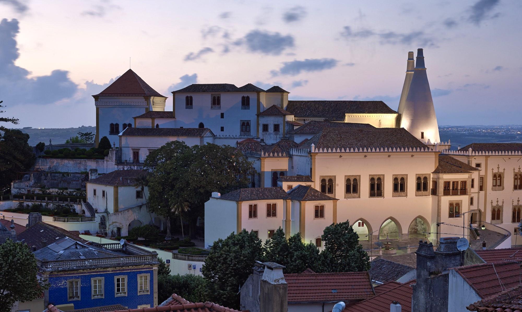 The National Palace of Sintra, crowned by its two gigantic conical chimneys, has been an iconic feature of the Sintra landscape for many centuries. – © PSML / Angelo Hornak