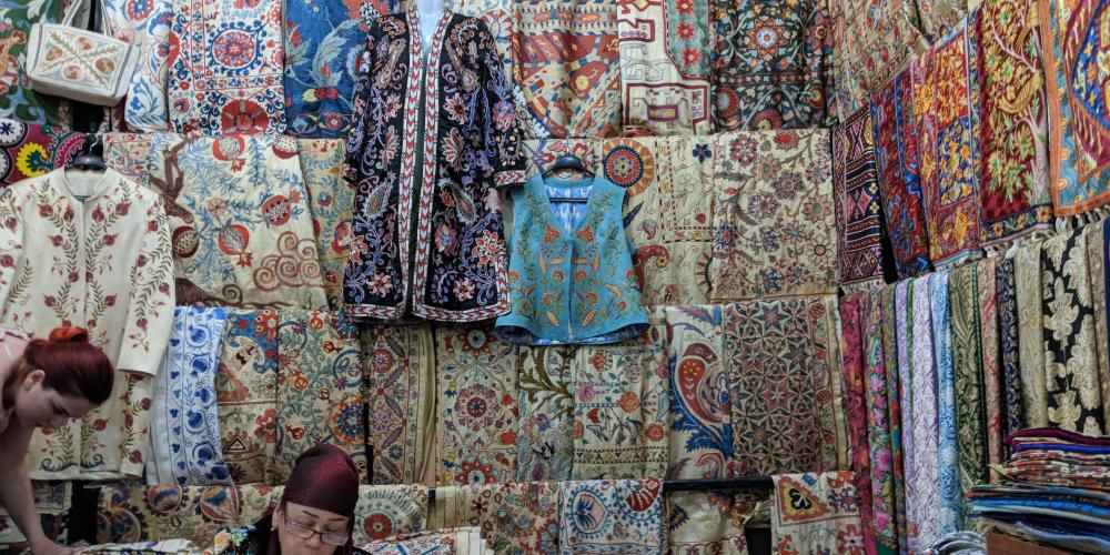 Uzbek woman sells traditional wear – Photo by Brian Ma