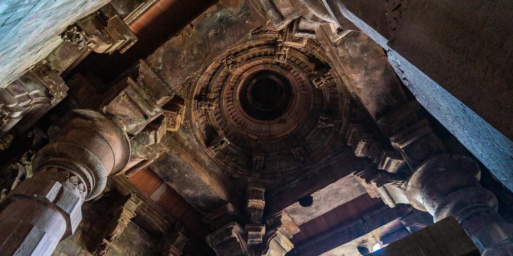 Sculptures are carved into the ceiling of the temple sanctum but the interior decorative work wasn’t completed. – © Michael Turtle