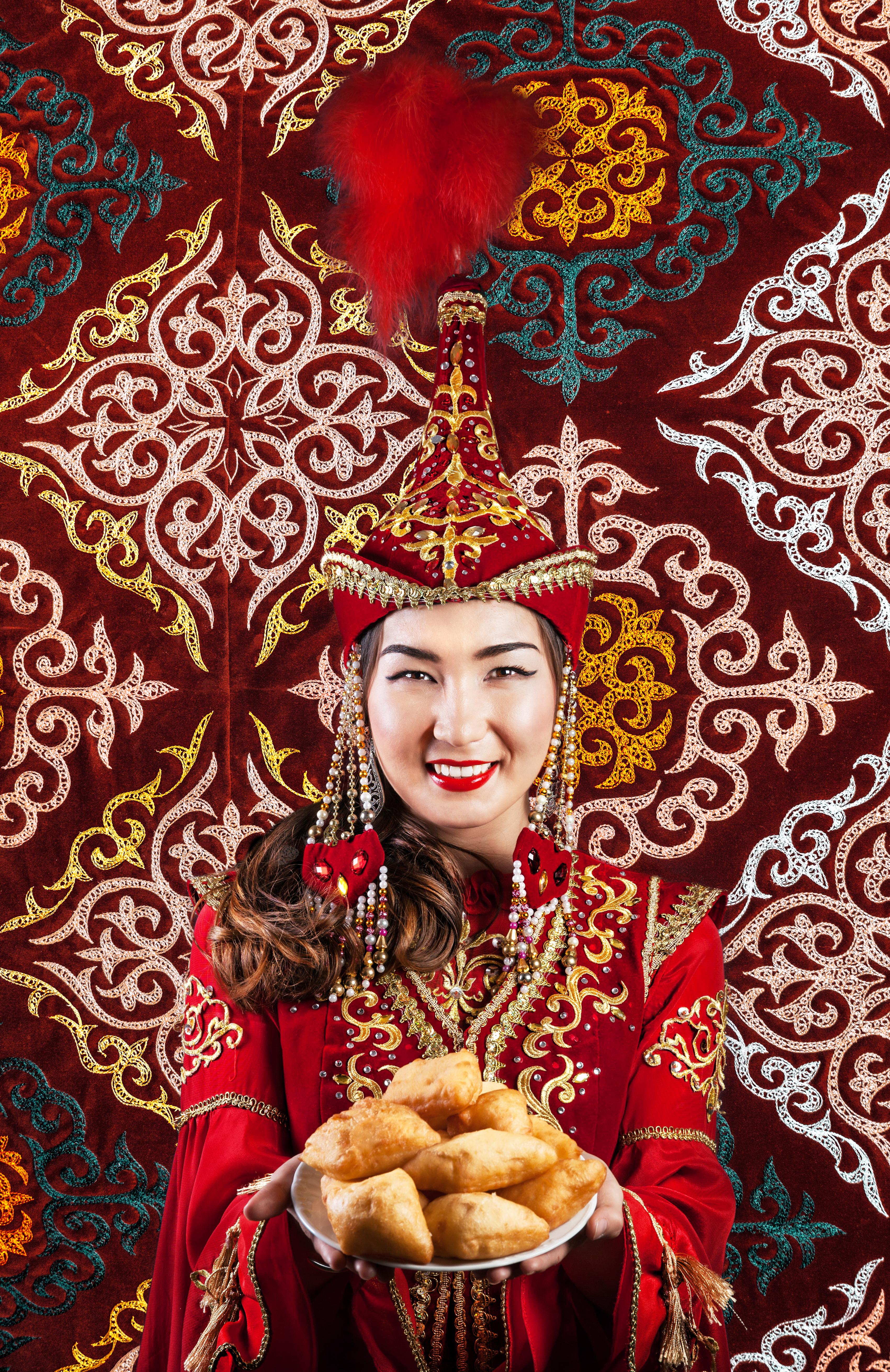 A Kazakh woman in traditional dress / Credit: https://www.shutterstock.com/g/pikosokz