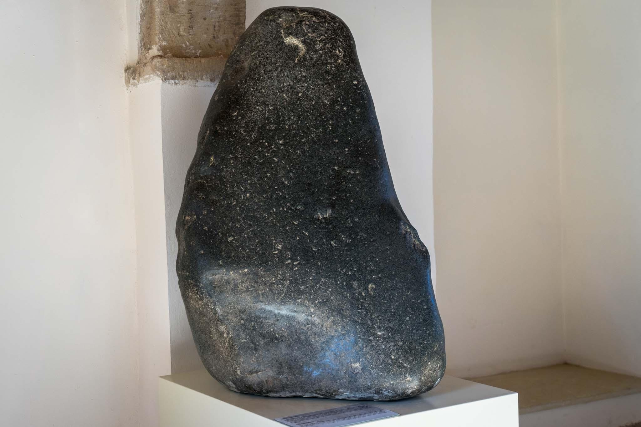 The black basalt stone that represented the Goddess of Cyprus is on display at the museum at the Sanctuary of Aphrodite. – © Michael Turtle