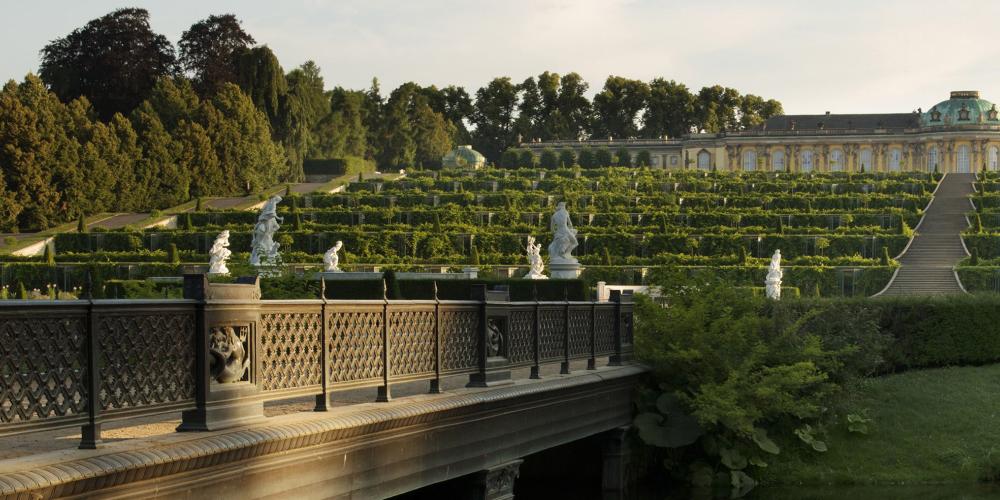 Elegantly placed to accentuate its length—and seemingly untouched by time— Sanssouci Palace sits upon the plateau of a vineyard. Sanssouci Palace, built by Georg Wenzeslaus von Knobbelsdorff in only a two-year construction period, is a major work of German Rococo architecture that was the favorite residence of Frederick the Great. – © L. Seidel / SPSG Elegantly placed to accentuate its length—and seemingly untouched by time— Sanssouci Palace sits upon the plateau of a vineyard. Sanssouci Palace, built by Georg Wenzeslaus von Knobbelsdorff in only a two-year construction period, is a major work of German Rococo architecture that was the favorite residence of Frederick the Great. – © L. Seidel / SPSG