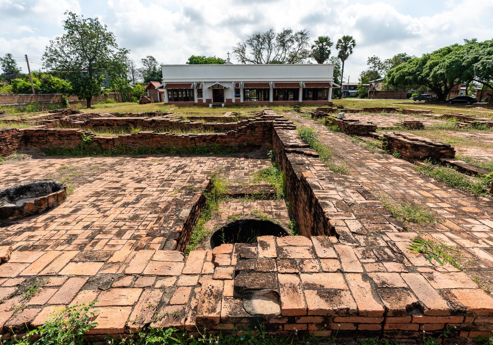 The remains of foundations in the Portuguese Village lie in front of a small museum with information about the settlement's history. – © Michael Turtle