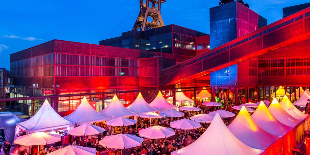 En été, de nombreux événements en plein air ont lieu à Zollverein. Un des plus populaires est organisé en août : le Gourmetmeile Ruhr, un festival gastronomique où de nombreux chefs d'Essen présentent leurs talents et leurs spécialités régionales. – © Jochen Tack / Zollverein Foundation