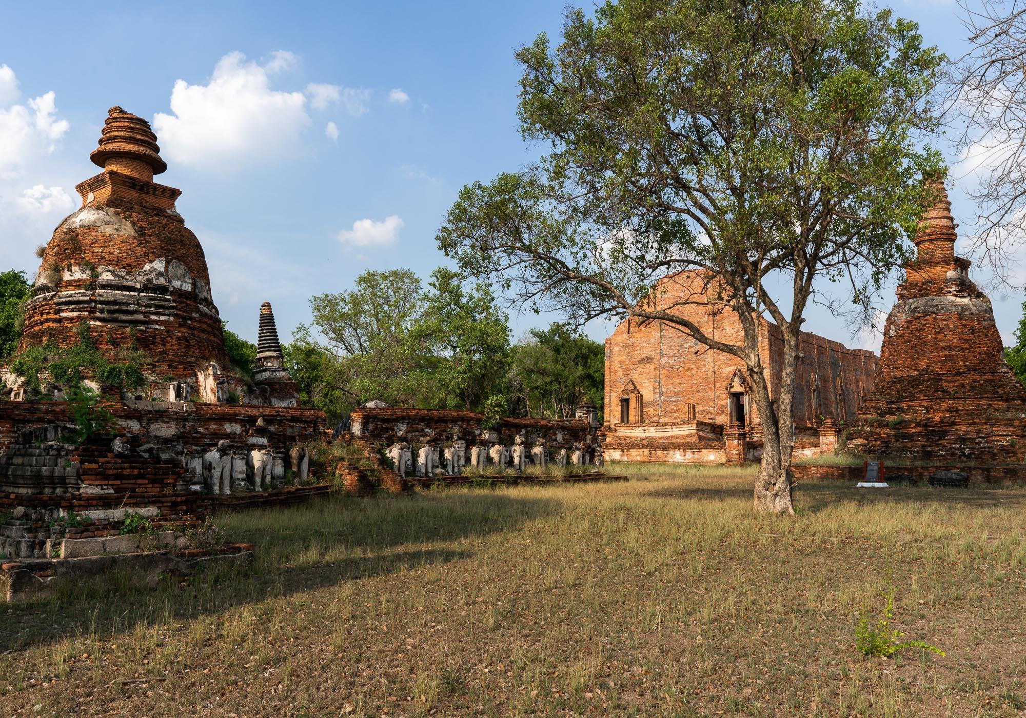 Looking across Wat Maheyong, with the bell-shaped stupa on the left and the large ordination hall on the right. – © Michael Turtle
