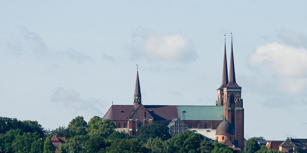 Roskilde Cathedral sits on a hilltop overlooking Roskilde fjord. Different cathedrals have stood here since the 10th century. – © Jan Friis