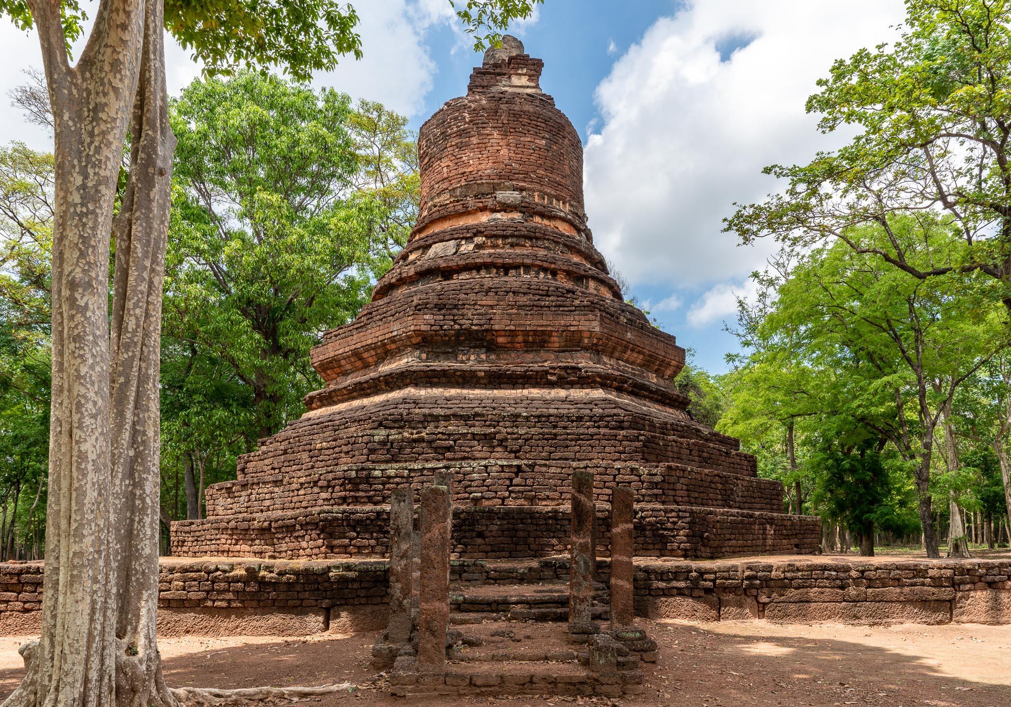 Wat Phra Non's main pagoda, which is interesting because of a mix of styles starting with an octagonal base leading up to the slender bell shape. – © Michael Turtle