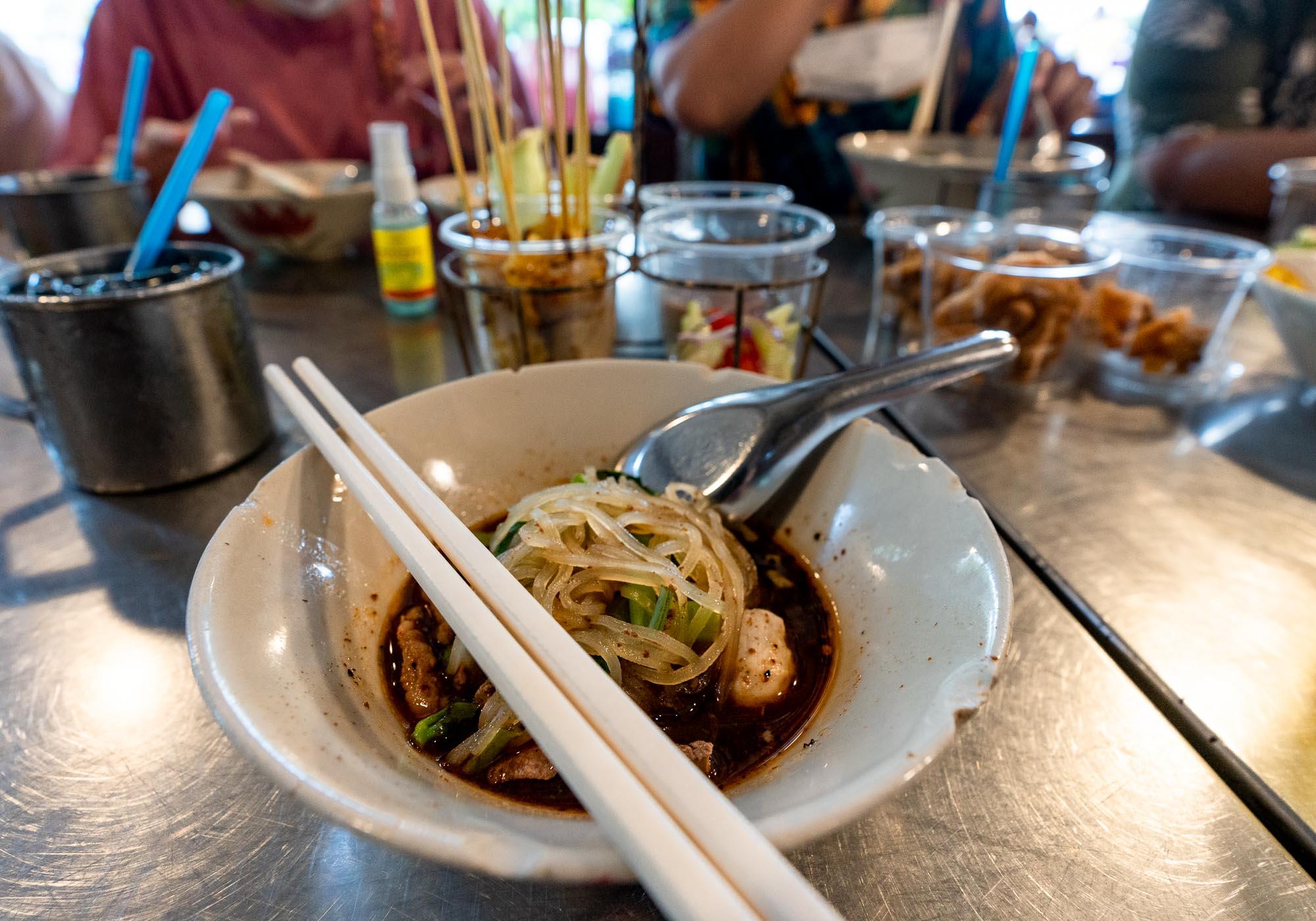 The noodles are traditionally served with a dark broth and pork or beef, along with a few meatballs. – © Michael Turtle