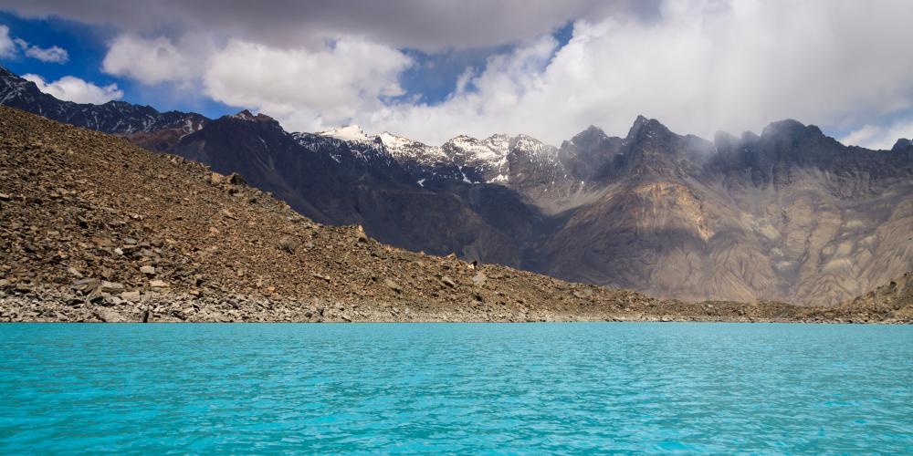 The crystal clear blue water of Sarez Lake. – © Nodir Tursunzade / Shutterstock