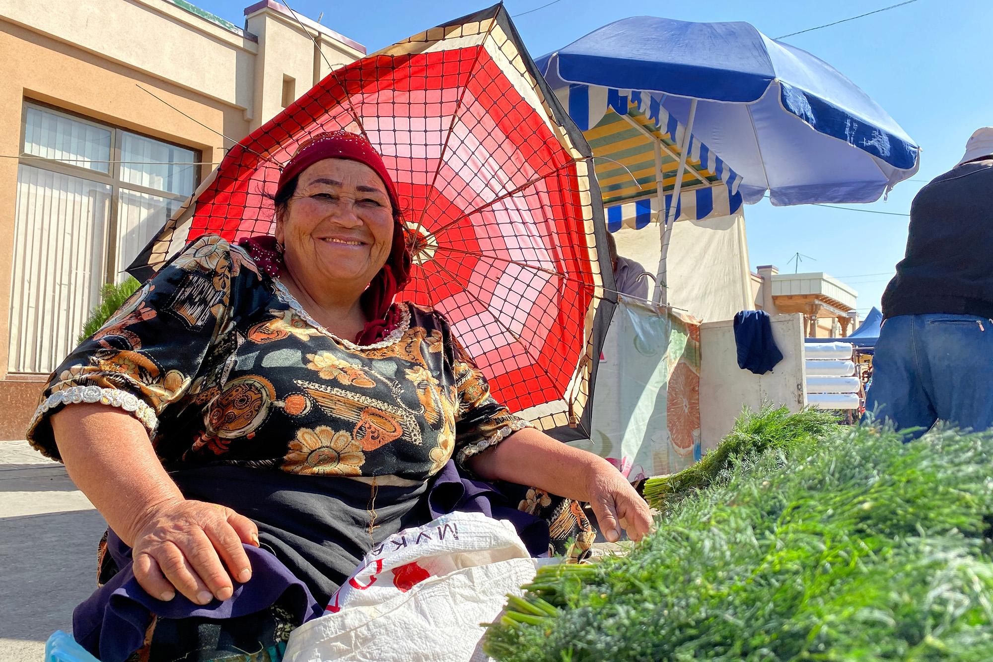 A vegetable seller smiles at Siab Bazaar in Samarkand – © Shee Heng Chong