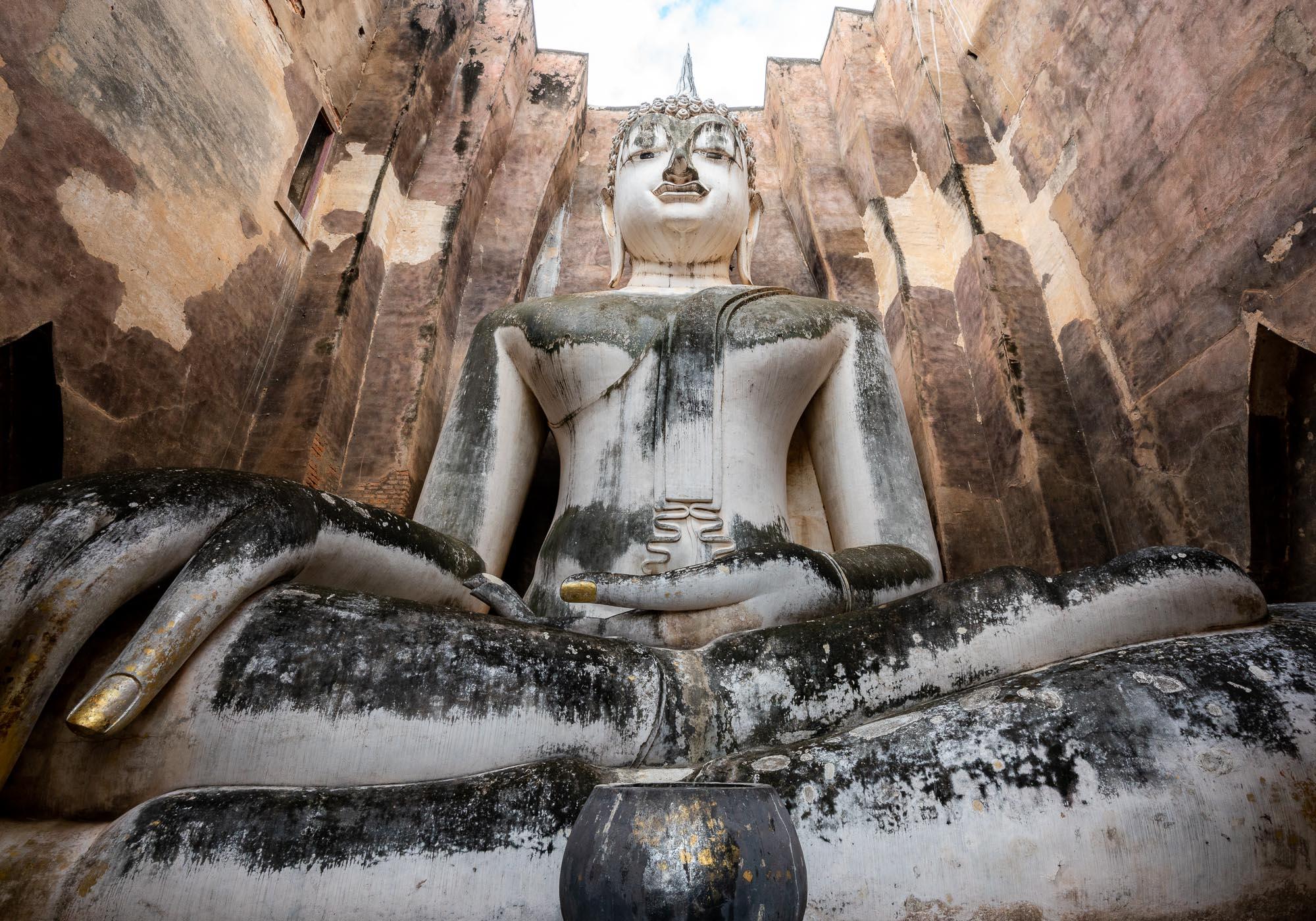 The 15-metre-high Buddha statue at Wat Si Chum has a secret staircase in the wall leading to a window near the statue's head. – © Michael Turtle