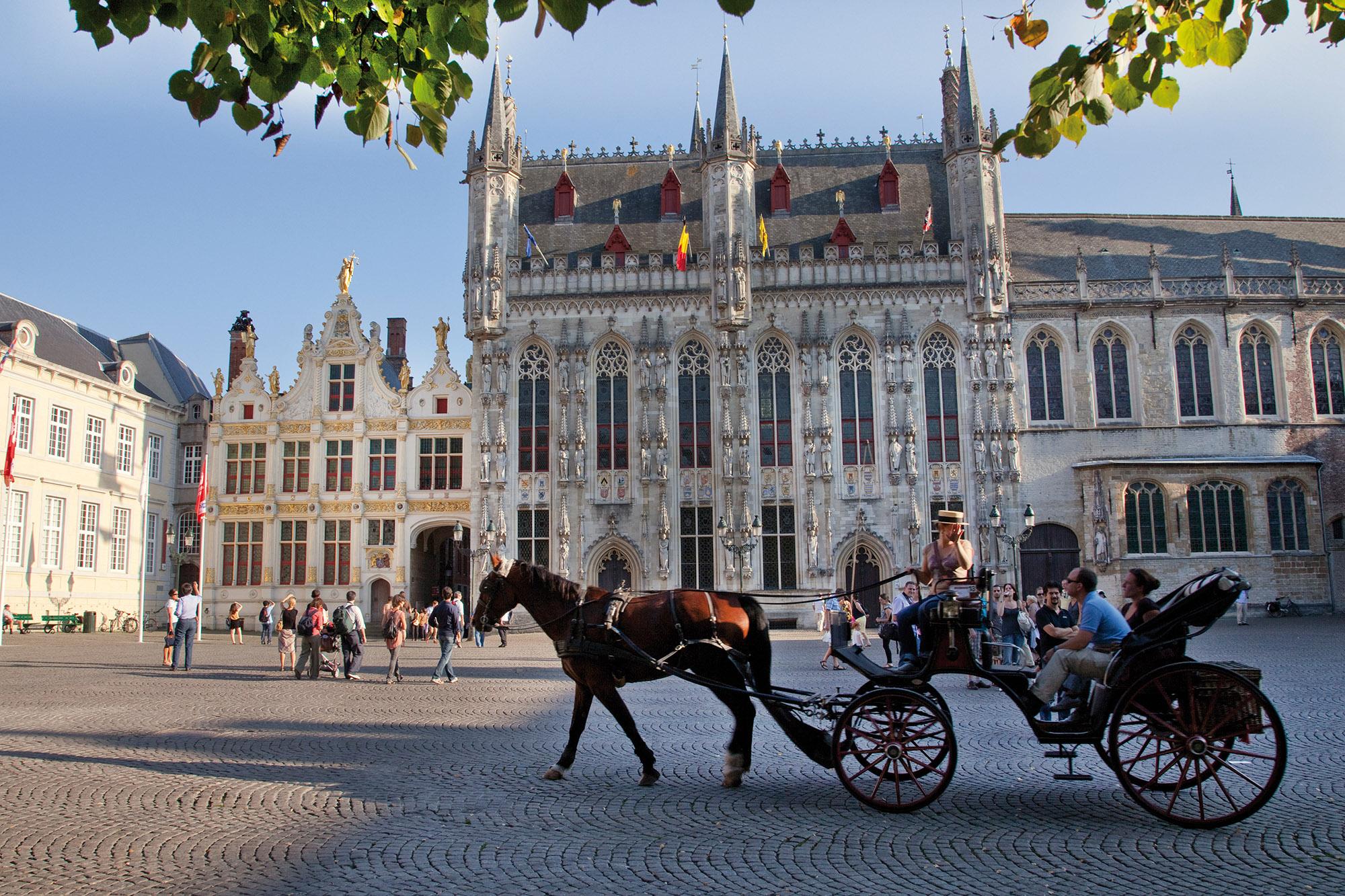 The Burg Square with the 14th-century city hall, the old Court of Justice, and the Basilica of the Holy Blood. - © Jan D. Hondt / VisitBruges