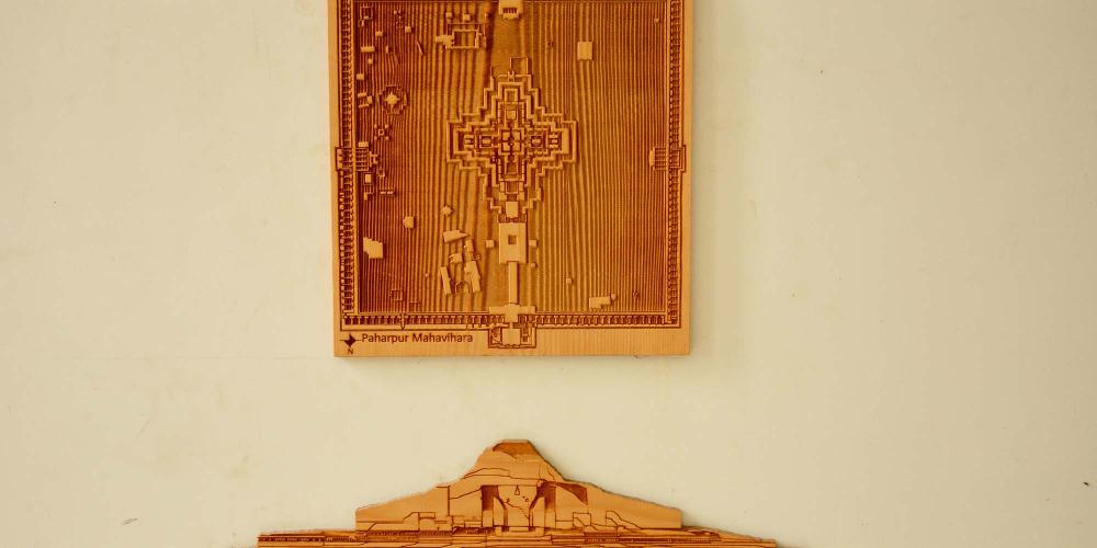 Wood work on the foyer wall of the museum depicting the central temple's elevation and ground plan. – © Md. Shahriar Omar Sadh