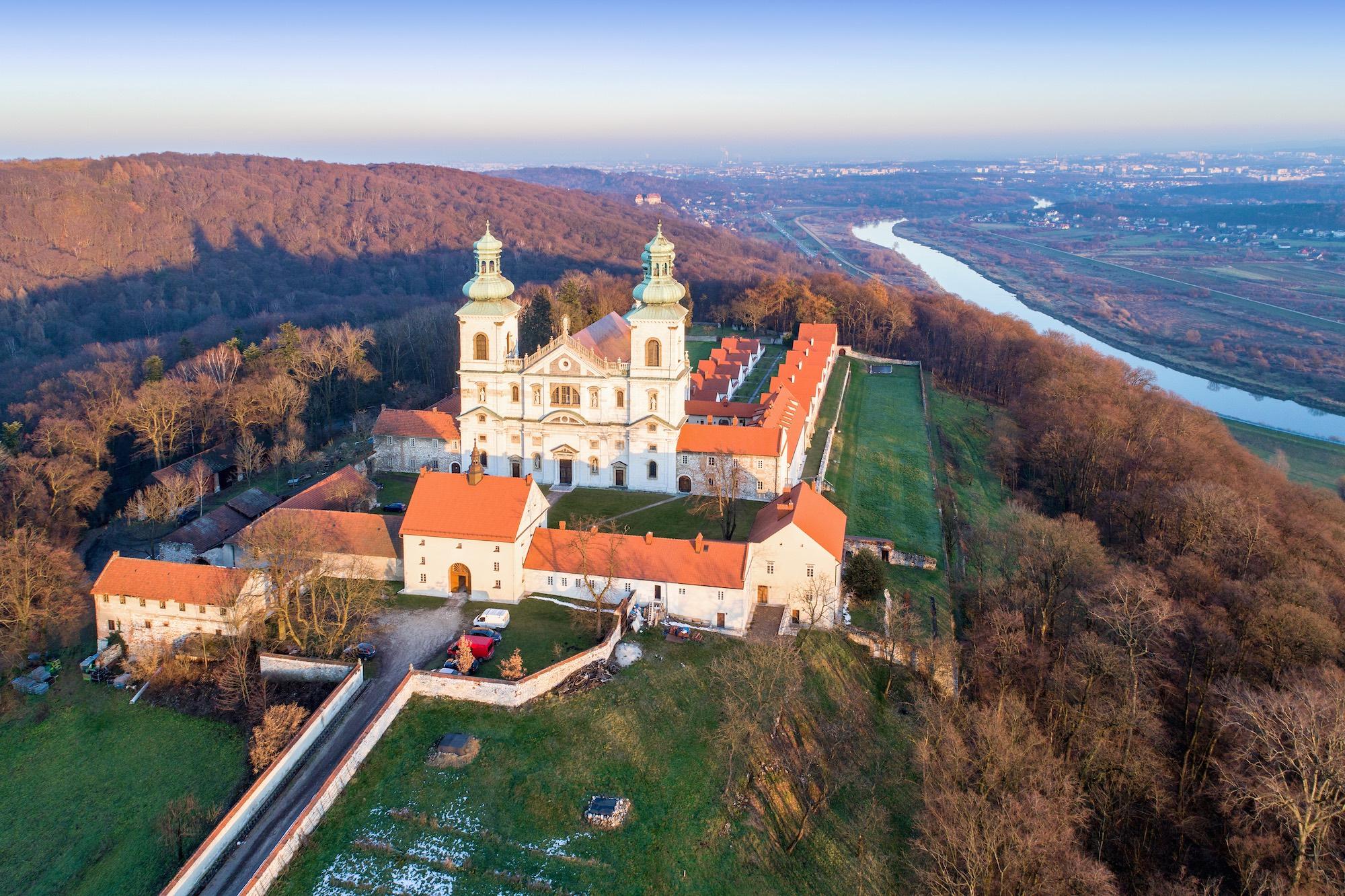 The Camaldolese Hermit Monastery at Srebrna Góra is a place of contemplation, isolation, and monastic spirituality. The interior features rich stuccoes and 17th-century paintings of Italian masters. Its hillside features a large vineyard and winery with a tradition dating to the 10th century. It is open for visitors, yet women can only enter it on 12 designated days of the year. – © Nahlik