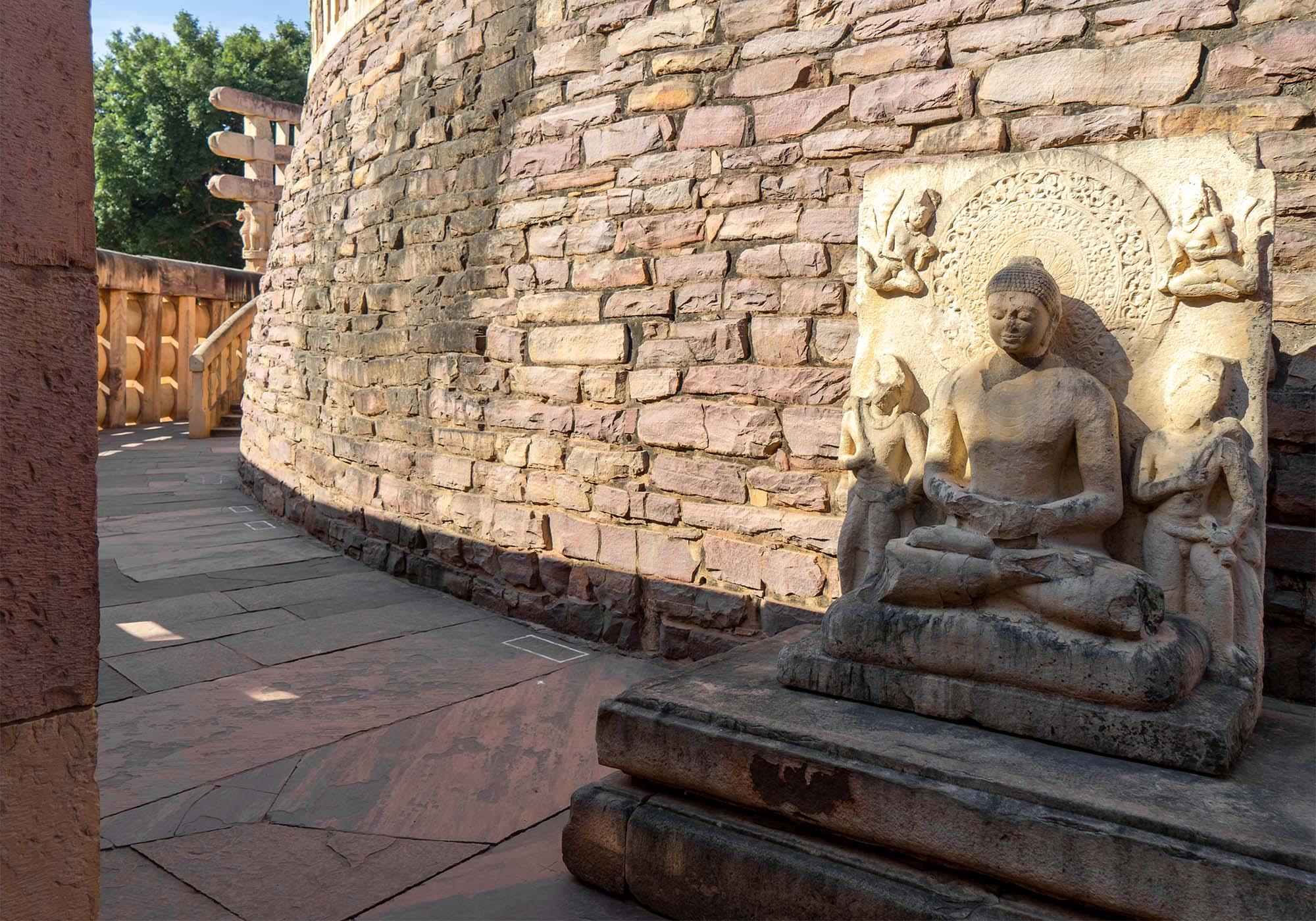 The sculpture of Buddha in dhyana-mudra at the eastern side of the stupa, added to the site in the 5th century AD by the Guptas. – © Michael Turtle