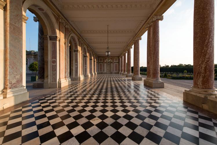 The Grand Trianon was erected by Jules Hardouin-Mansart in 1687, commissioned by Louis XIV to get away from the arduous pomp of life in the court and to pursue his affair with Madame de Montespan. This little palace of pink marble and porphyry is perhaps the most refined architectural ensemble found on the royal estate of Versailles. – © Thomas Garnier