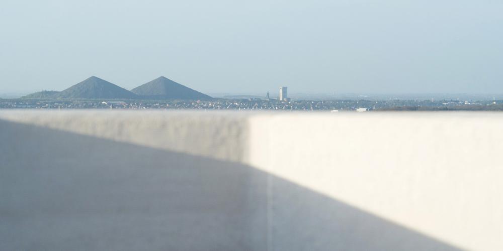 Take in the site's unassuming artistry with a poetic and refined look at the twin slag heaps of Loos-en-Gohelle from the Canadian Vimy Memorial. – © Jean-Michel André