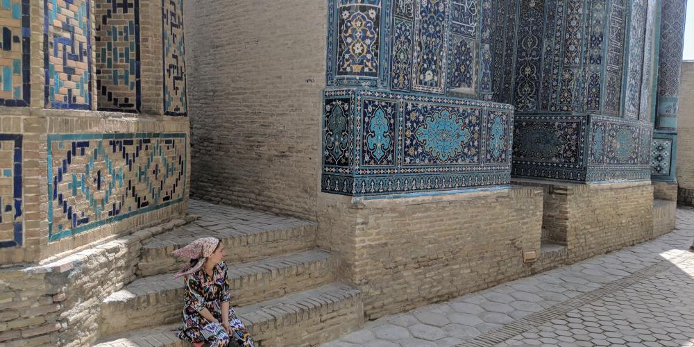 A woman sits on steps against a beautiful patterned backdrop – Photo by Brian Ma
