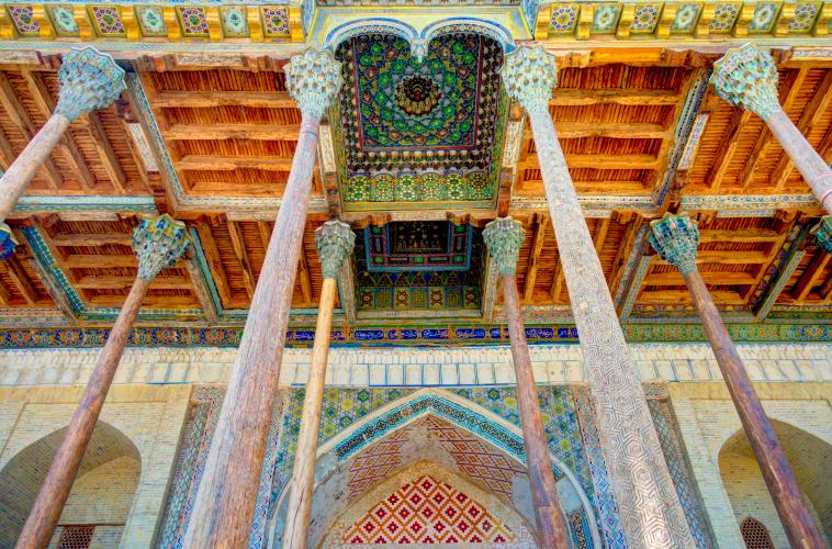 Intricate columns, walls, and ceiling designs in Bolo Hauz mosque, Bukhara, Uzbekistan – © mehdi33300 / Shutterstock