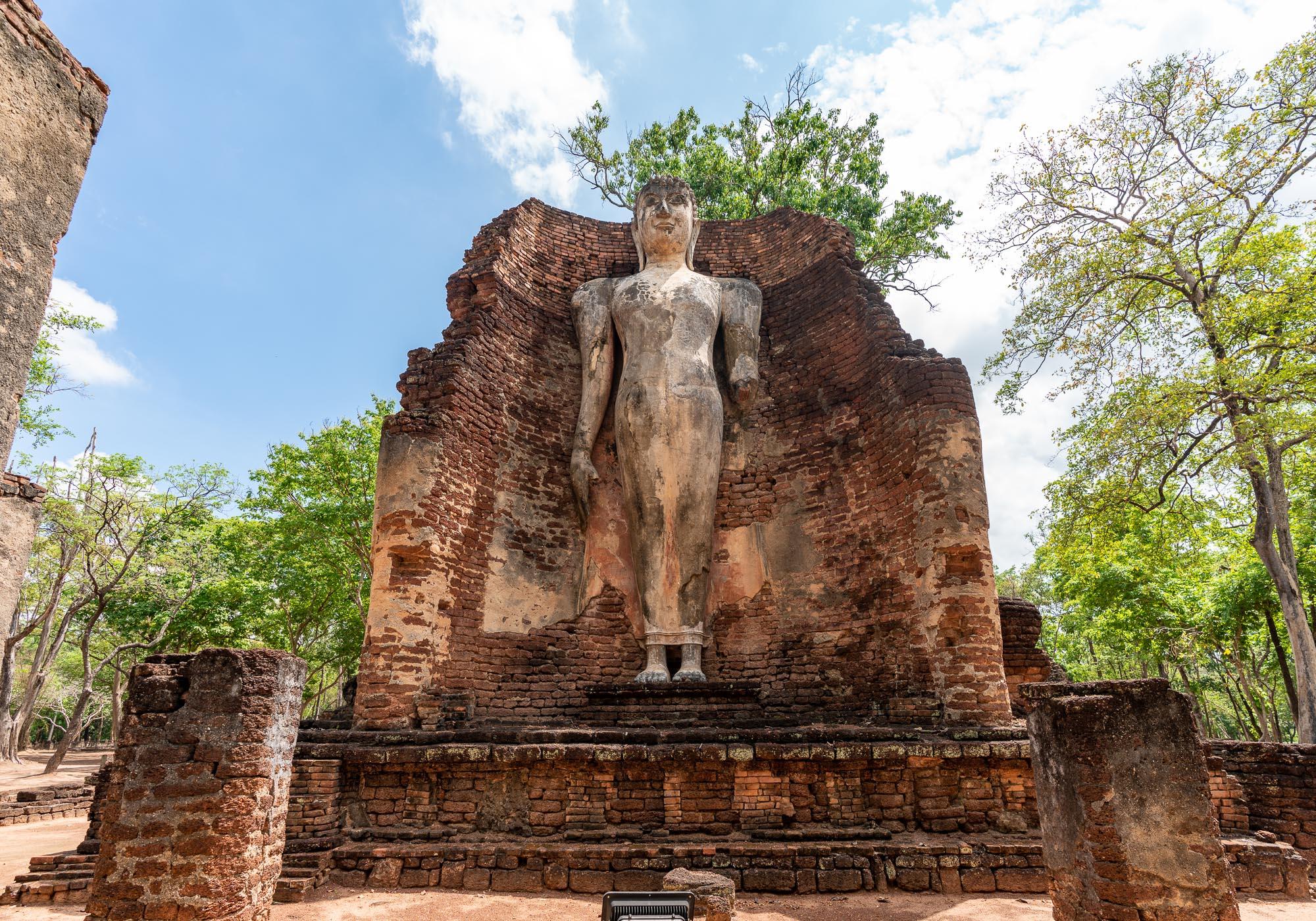 A standing Buddha on one side of a building in Wat Phra Si Ariyabot that would once have had different Buddha images on each cardinal point. – © Michael Turtle