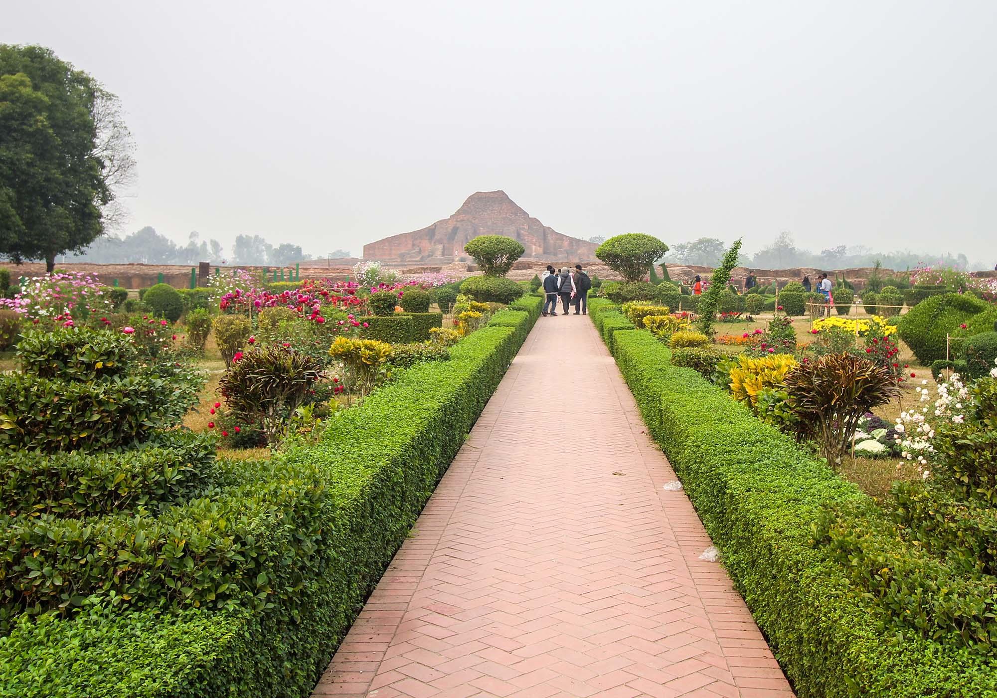 Entering the monastery quadrangle at Paharpur through a colourful surrounding garden. – © Roni Kabir Nurul