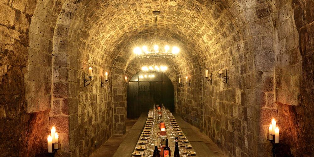 The small tasting room in the traditional cellar, where the light is always on, so the walls are not covered with mould, in order to show the stone in its fully beauty. – © Attila Kertesz