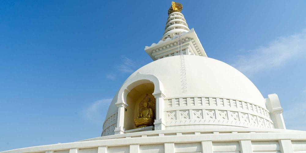There are golden statues of Buddha in different poses on the front and the back of the main stupa. – © Michael Turtle