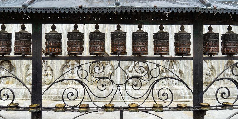 Prayer wheels circle the base of the main stupa at Swayambhunath. – © Michael Turtle Prayer wheels circle the base of the main stupa at Swayambhunath. – © Michael Turtle