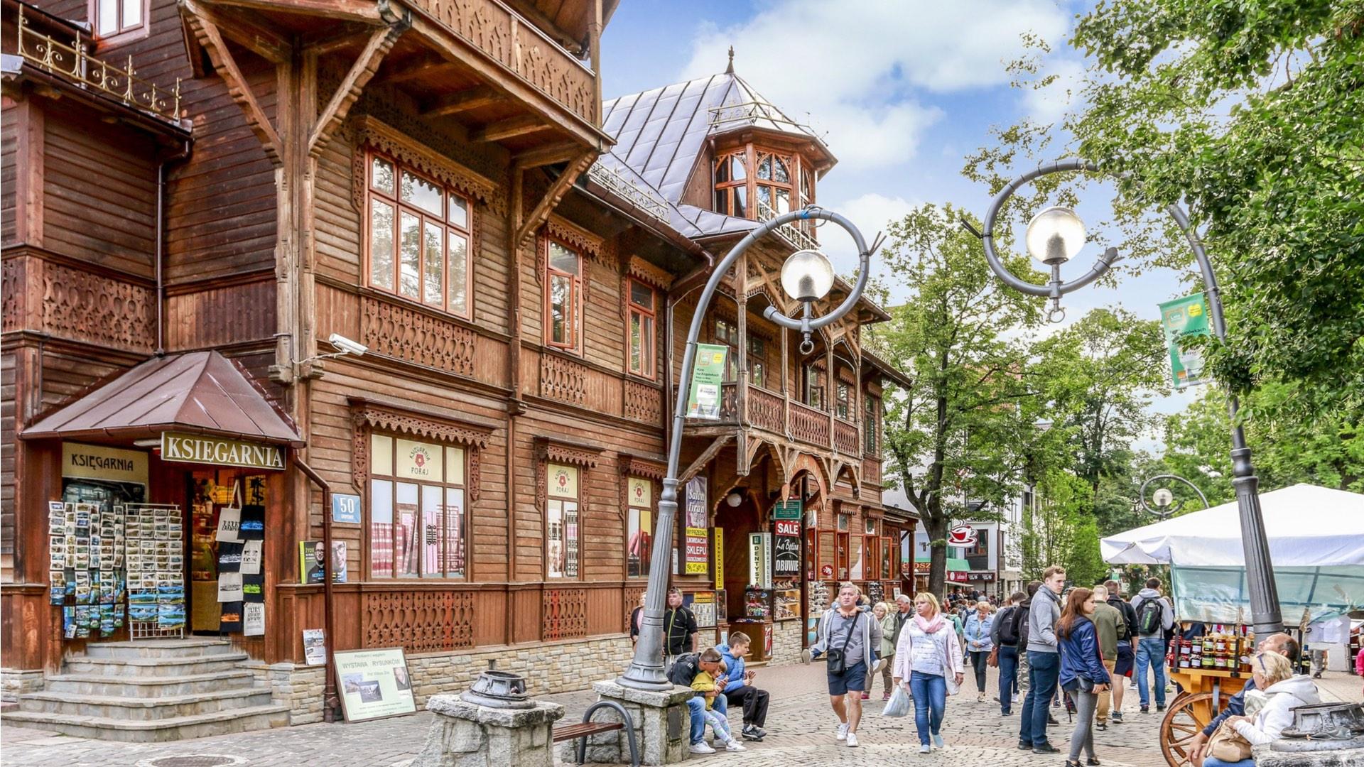 Krupówki Street, the busy pedestrian zone in Zakopane, is famous across Poland, with its charming century-old wooden town houses containing shops, restaurants and galleries. – © Agnes Kantaruk