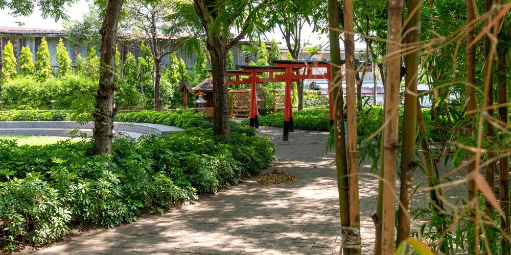 Tori gates, a Shinto shrine, and bamboo are part of the landscaping on the site of the Japanese Village. – © Michael Turtle