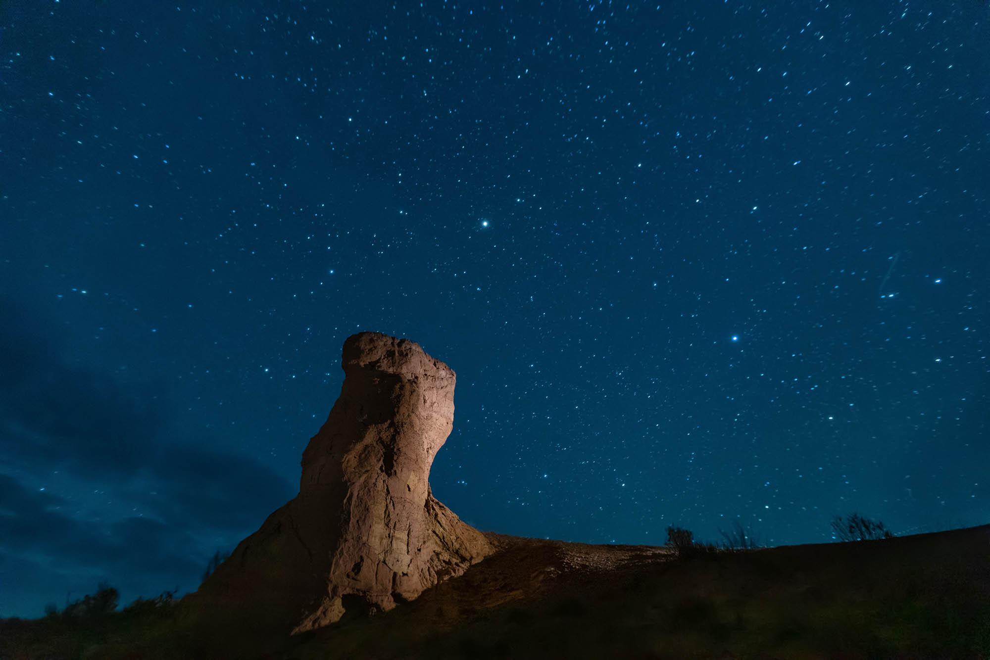 A stone pillar under the stars in Altyn-Emel National Park in Kazakhstan – © Sergey Dzyuba / Shutterstock