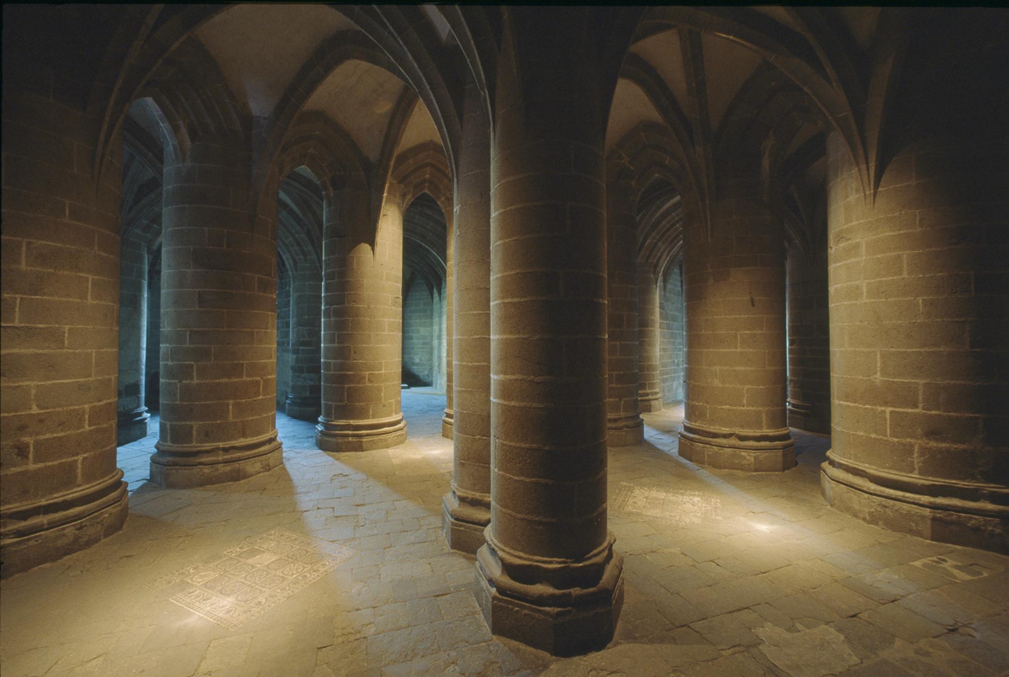 The site was inscribed twice on the World Heritage List. First in 1979, under the title "Mont-Saint-Michel and its Bay," and then in 1998 as the "Pilgrim's Way to Santiago de Compostela in France." Pictured: the Crypt of large pillars. – © Abbaye du Mont-Saint-Michel / CMN