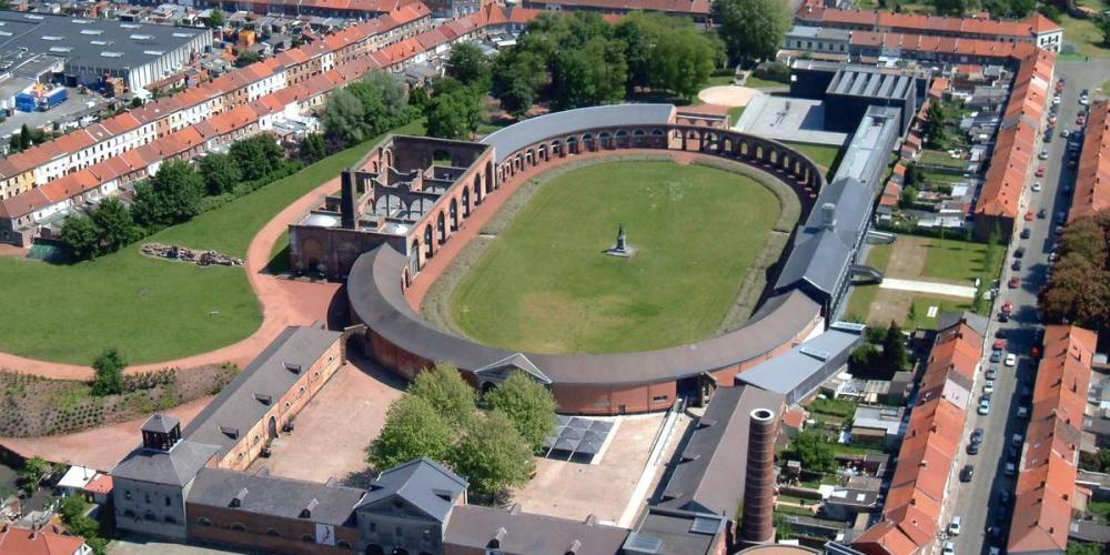 Grand Hornu is a monumental Neoclassical complex built in the 19th century—a former coalmine and workers' housing that now includes a building dedicated to design and the applied arts, and a museum of contemporary art. – © Visit Mons Grand Hornu is a monumental Neoclassical complex built in the 19th century—a former coalmine and workers' housing that now includes a building dedicated to design and the applied arts, and a museum of contemporary art. – © Visit Mons