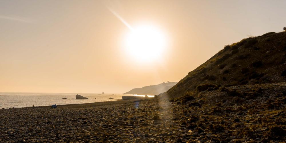 The setting sun, as seen from the Birthplace of Aphrodite. – © Michael Turtle