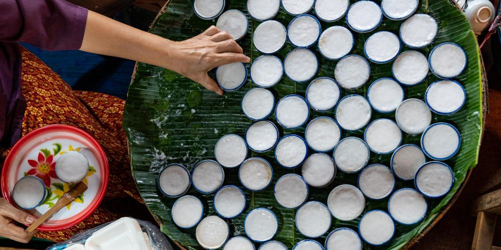 A popular coconut sweet called 'kanom tuay' being prepared at the Kong Khong Market near Ayutthaya. – © Michael Turtle