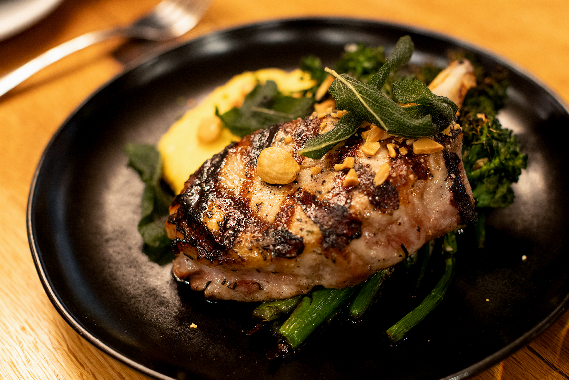 Grilled Bone-in Pork Chop artfully prepared at FINN. – FINN