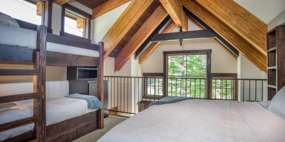 The loft bedroom sleeps 4 in a cozy king bed and 2 twin bunkbeds. – Trevon Baker