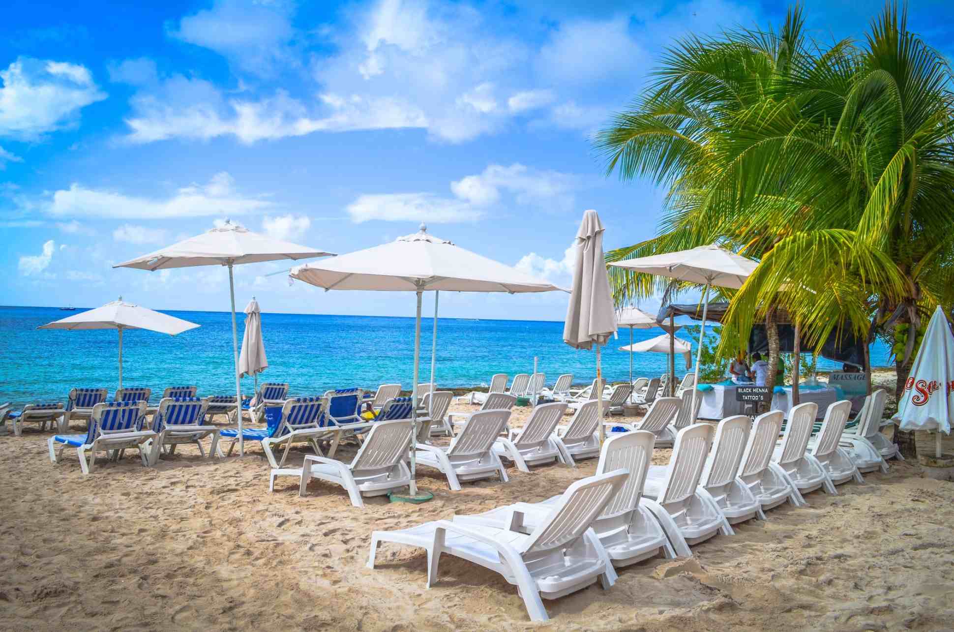 lounge chairs on sunny beach in cozumel
