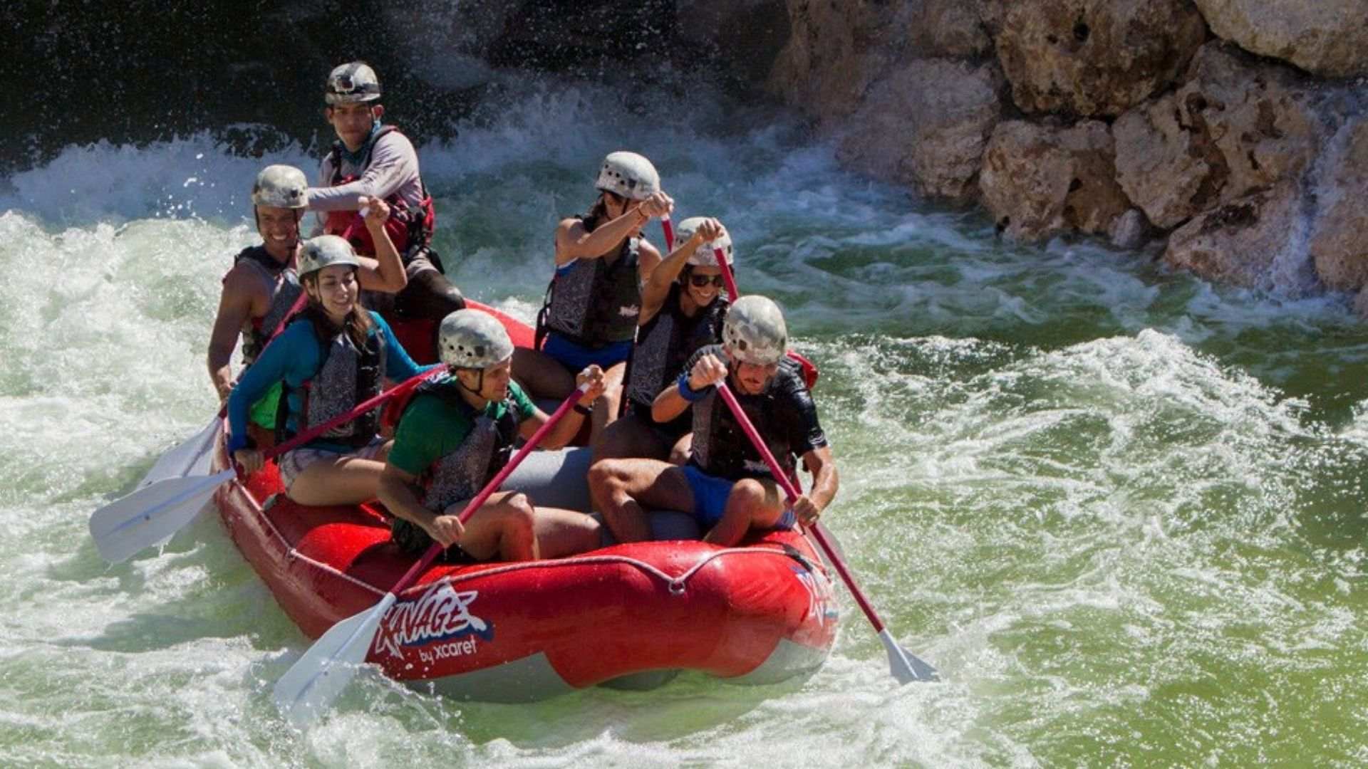 people in red whitewater raft