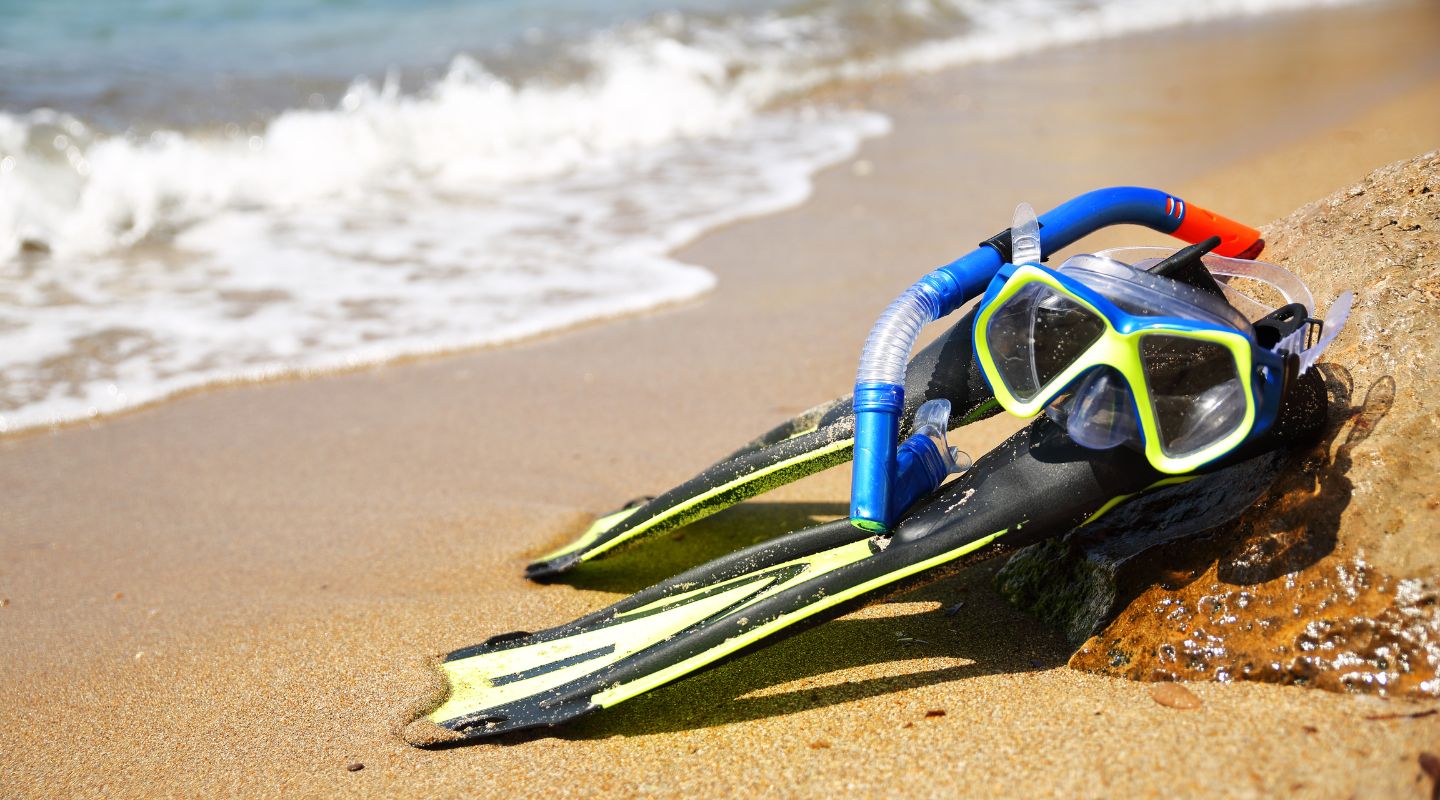 Snorkeling equipment laying on the sand
