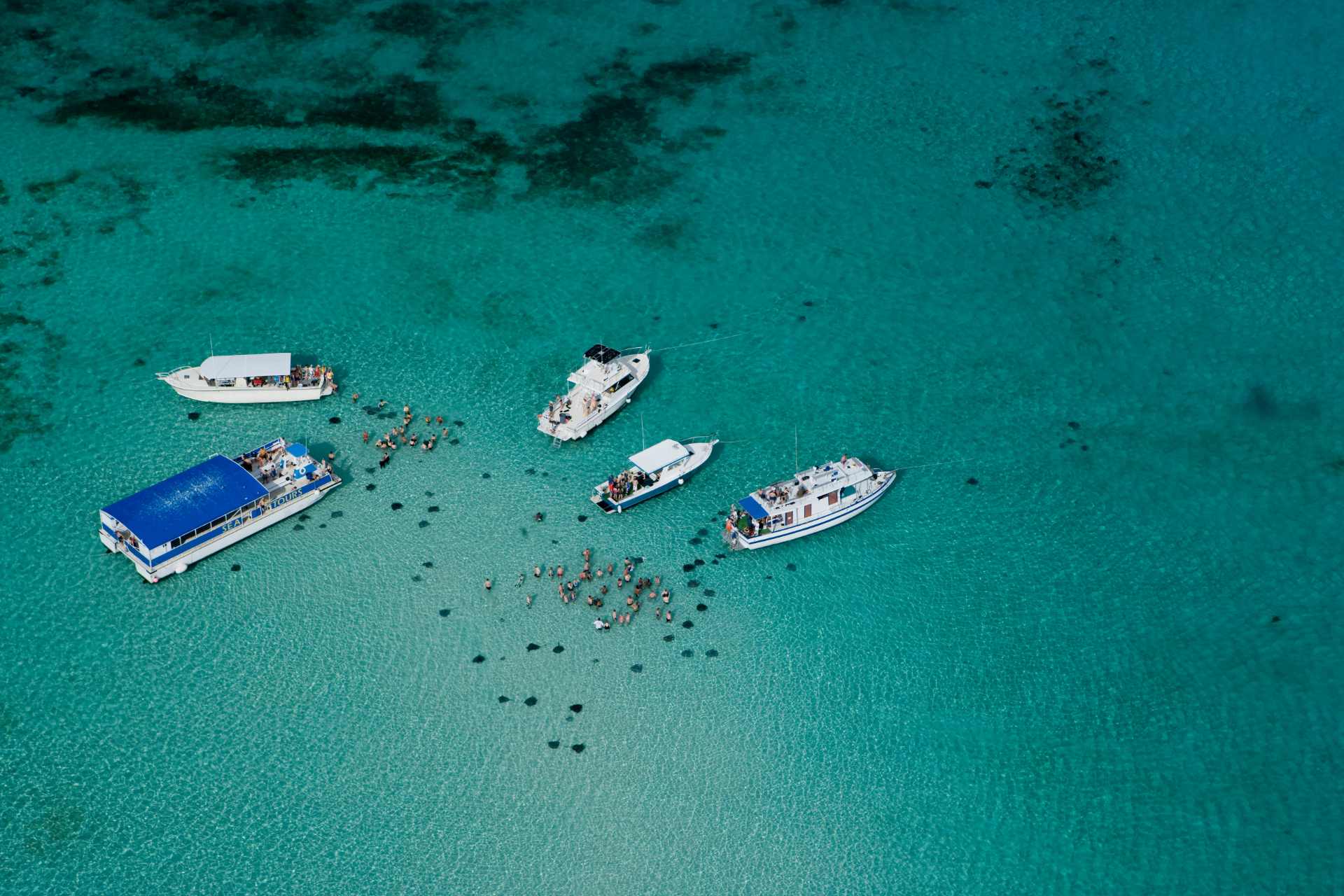 boats and people at Stingray City with drone view
