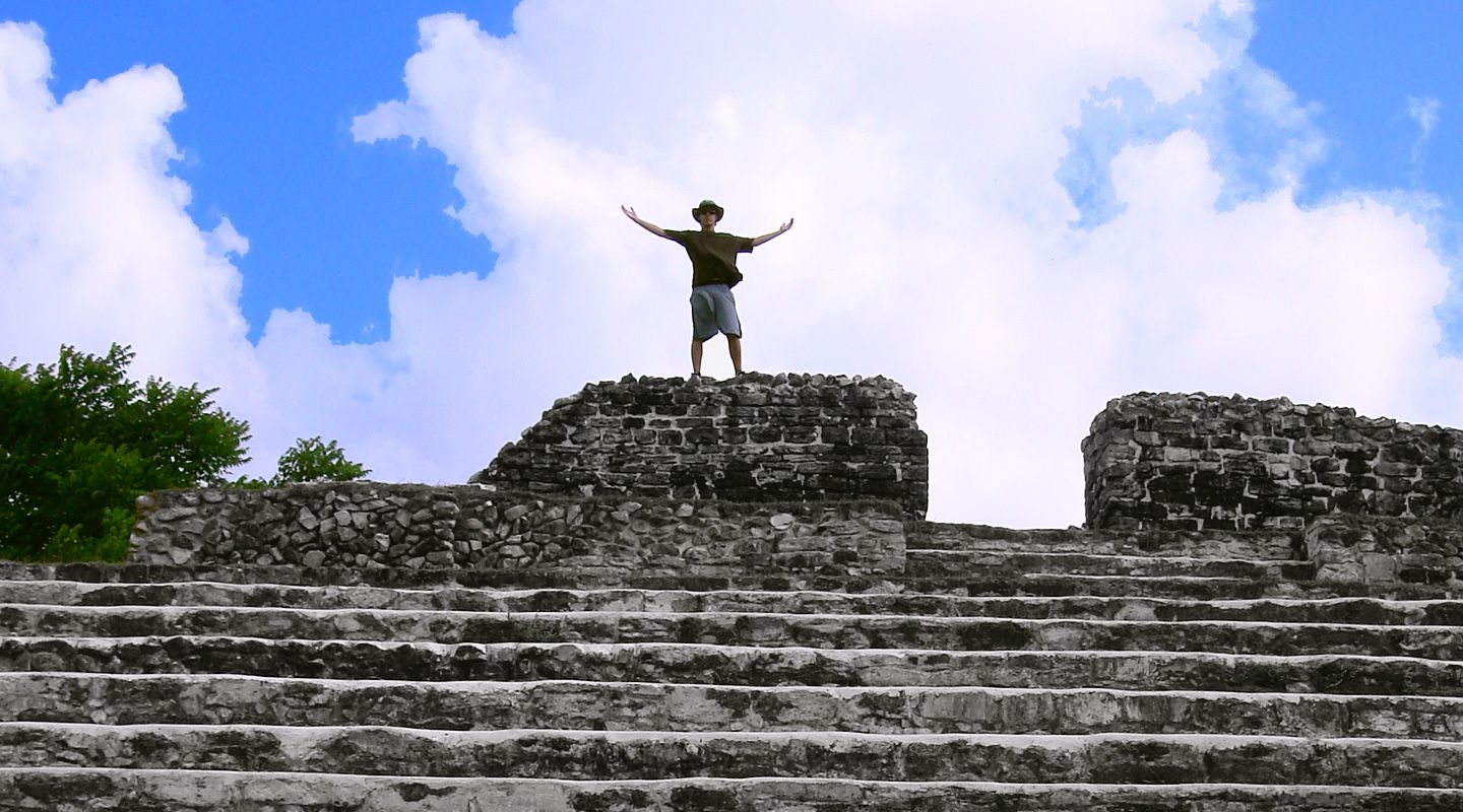 A traveler standing atop the Mayan ruins in Belize.