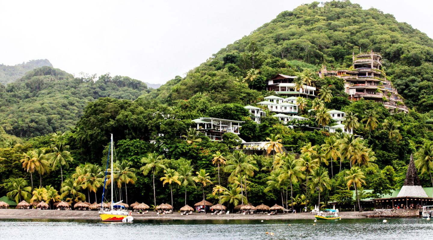 Photo of a Santa Lucia mountain, with a resort built on the side, overlooking the ocean.