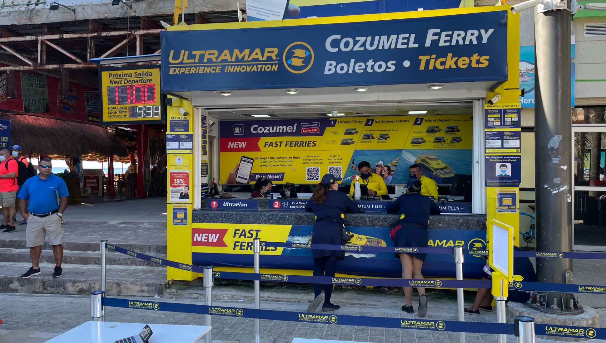 women standing at ticket booth