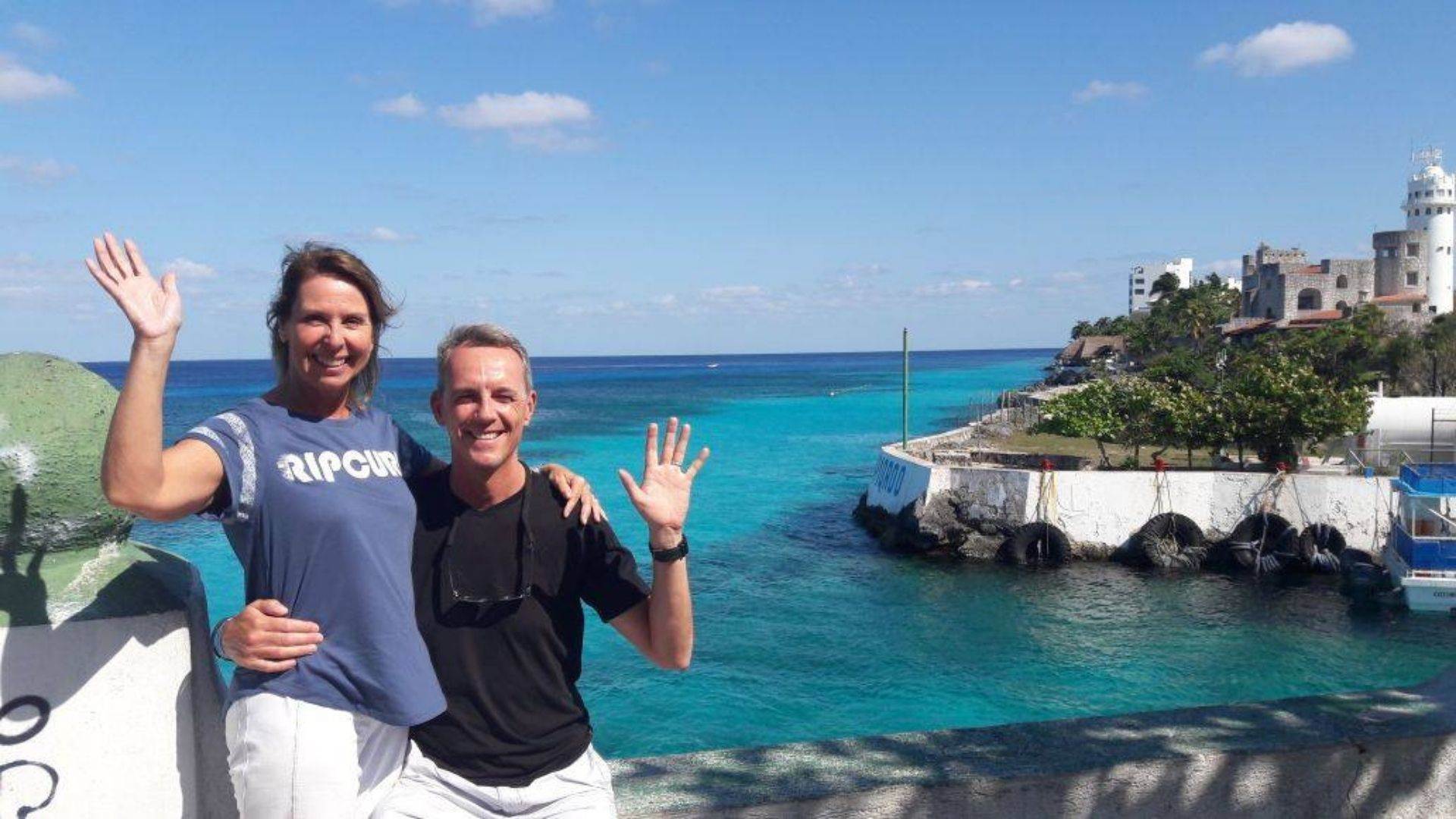 a couple in front of Cozumel beach